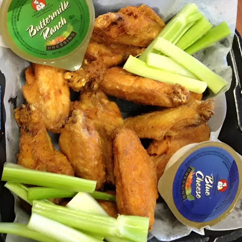 Crispy fried chicken wings with celery sticks, buttermilk ranch, and blue cheese dressing.